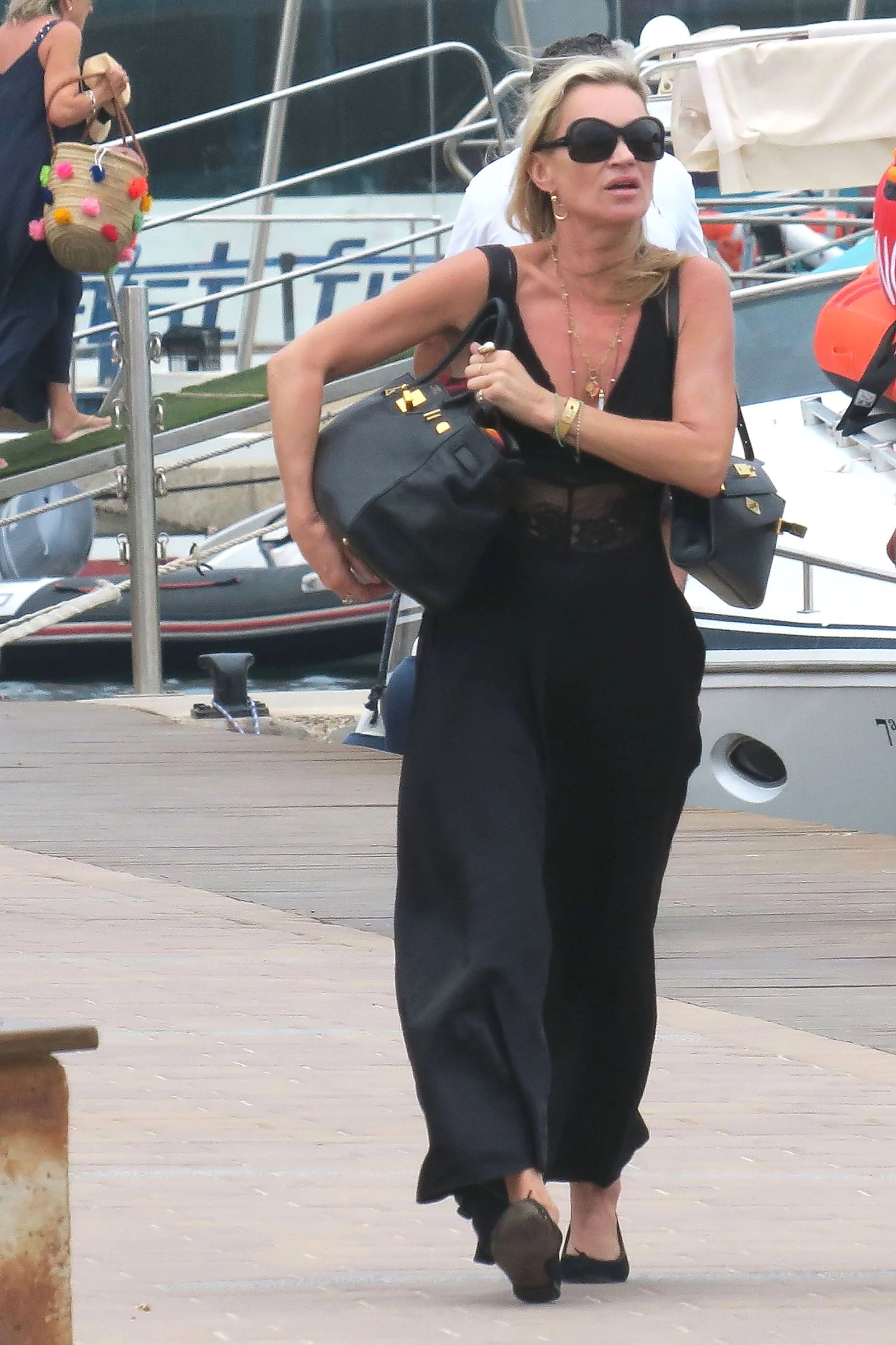 Image may contain Kate Moss Accessories Sunglasses Bag Handbag Water Waterfront Face Head Person and Photography