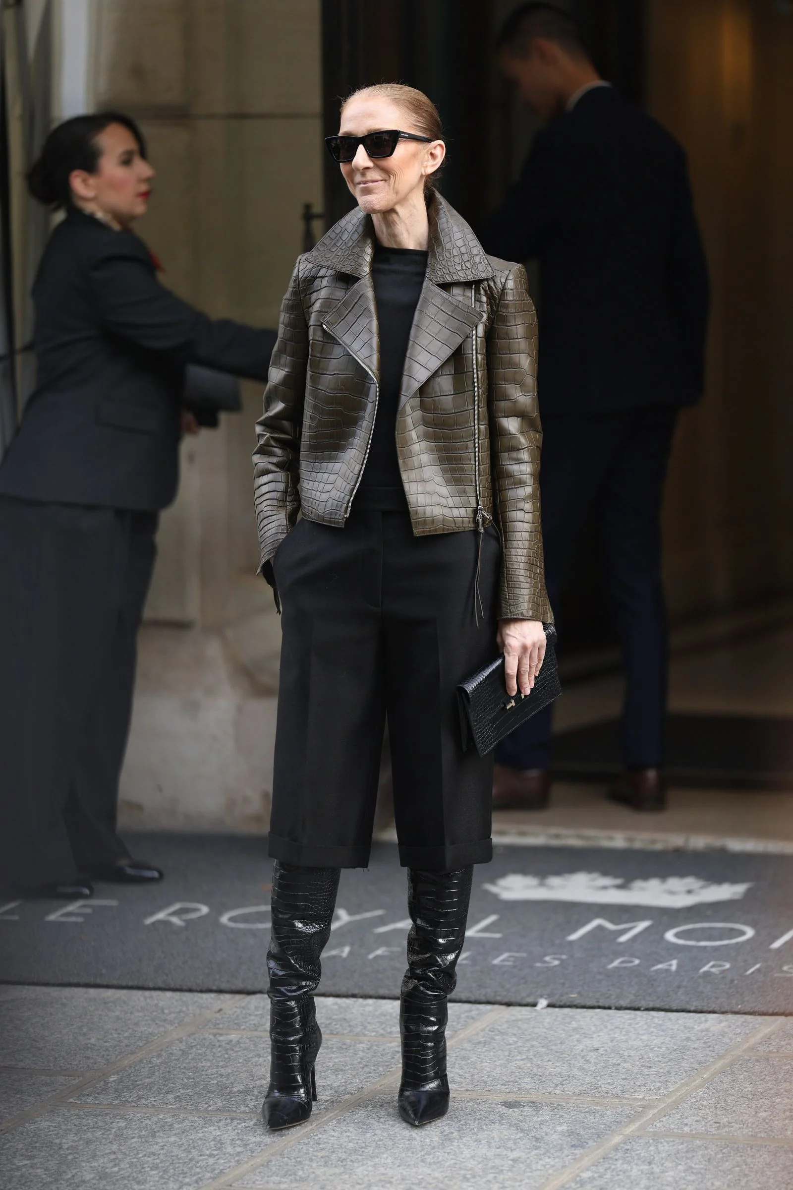 Image may contain Celine Dion Clothing Coat Jacket Formal Wear Suit Adult Person Accessories Bag and Handbag
